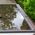 Clearing Debris to Prevent Water Pooling on Flat Roofs